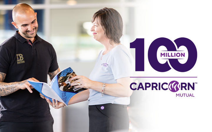 Capricorn's Area Sales Manager showing a brochure to a workshop owner