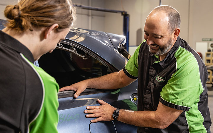 Two people working on car