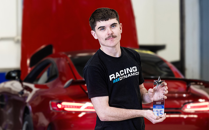Hudson Rhodes, 2025 Capricorn Rising Stars WA Region Winner, showcasing his trophy in front of a red high-performance sports car at Racing Dynamics.
