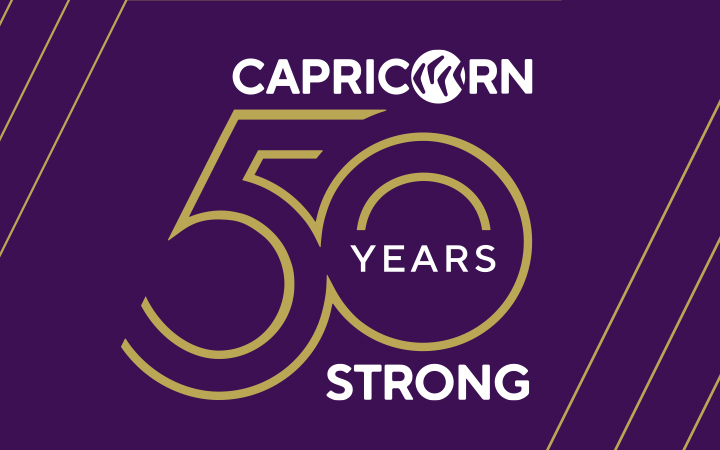 Capricorn 50 Years Strong logo with purple background and gold outline