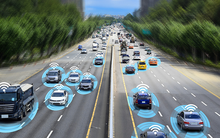 Cars on a highway with wireless icons, showcasing advanced driver assistance systems and evolving automotive technologies.