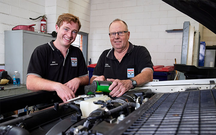 Two men working on car