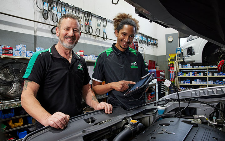 People working on car