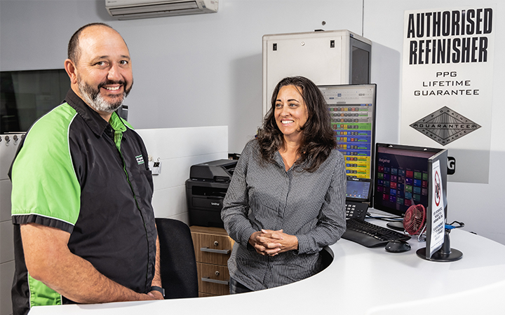People smiling in an auto business