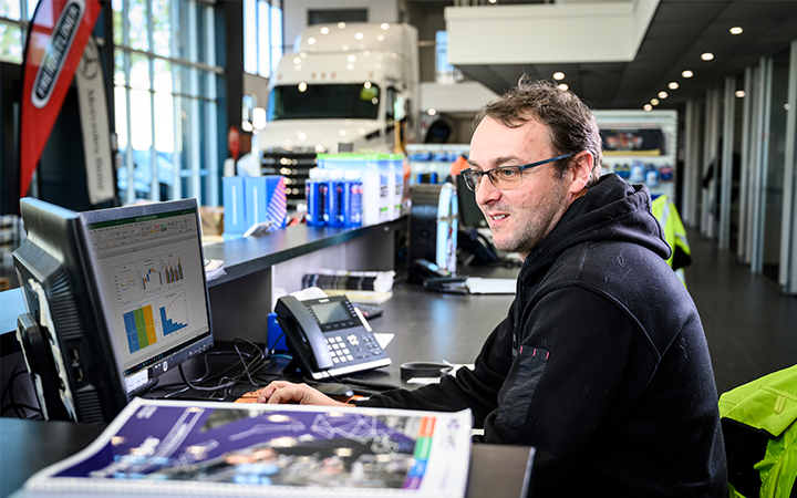 Man sitting at desk doing work on a computer