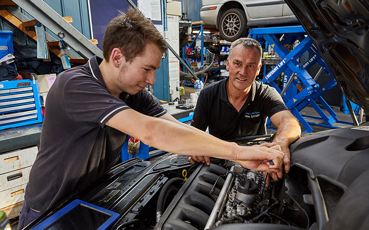 People working on car