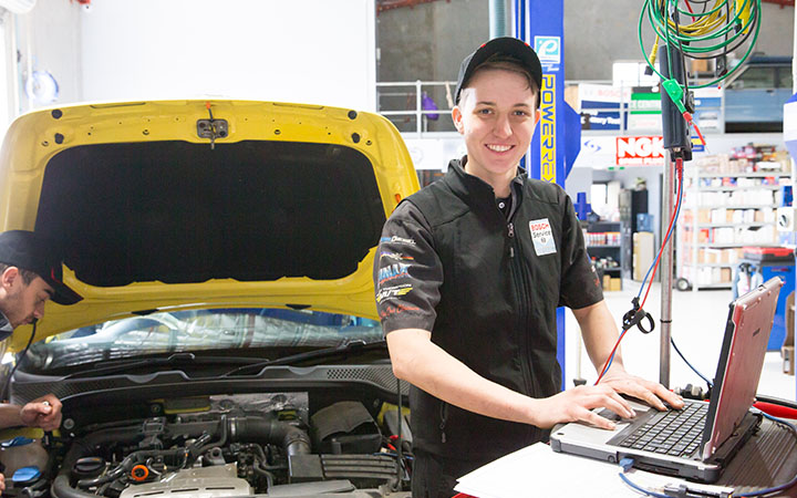 People fixing vehicle