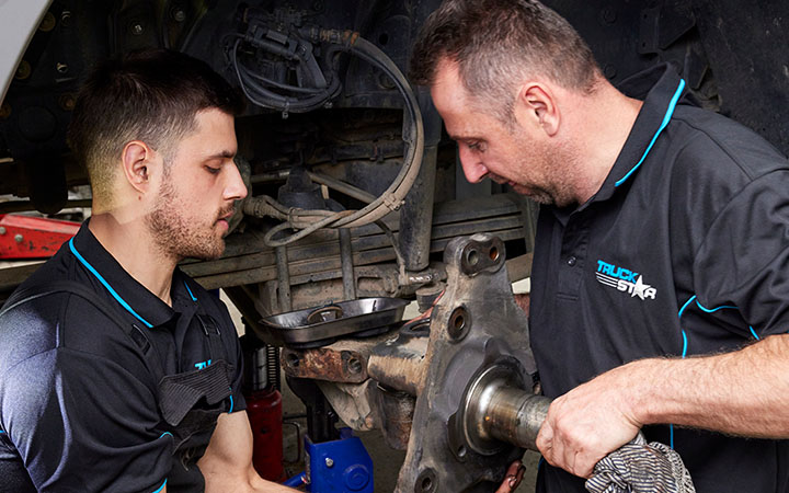 People working on vehicle