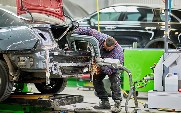 Mechanic working on a car in a garage.