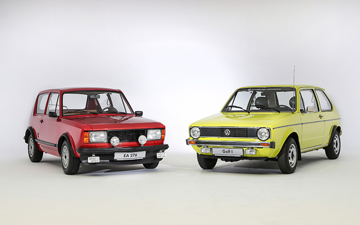 Two first-generation VW Golf cars parked side by side, showcasing their classic design and compact size.