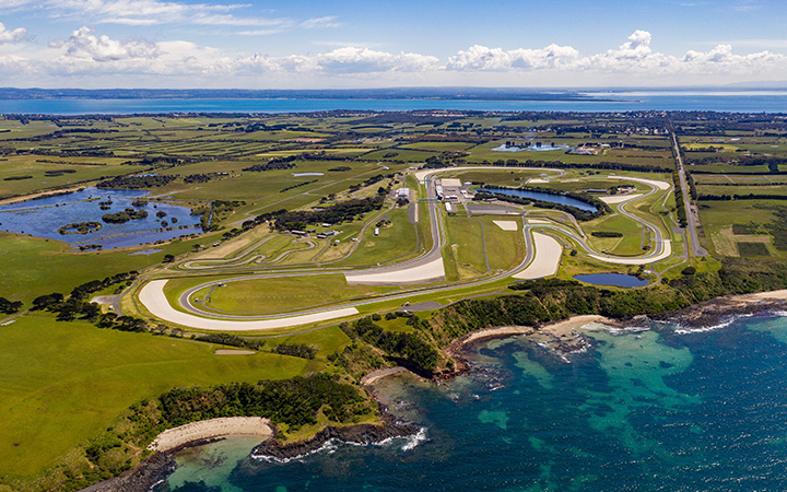 Aerial view of Phillip Island Circuit in Australia, showcasing the race track and surrounding landscape.