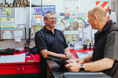 Roy Turner shaking hands with a Capricorn Area Manager.