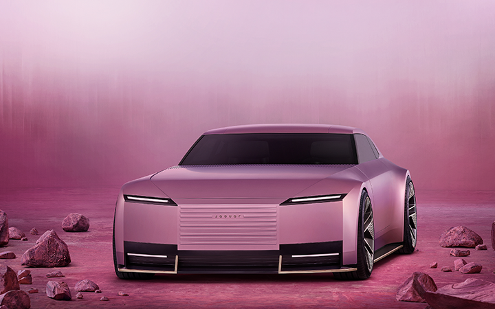 A pink jaguar Type 00 concept car on a pink landscape featuring pink rocks