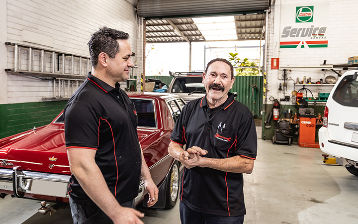Technicians talking and smiling in the workshop