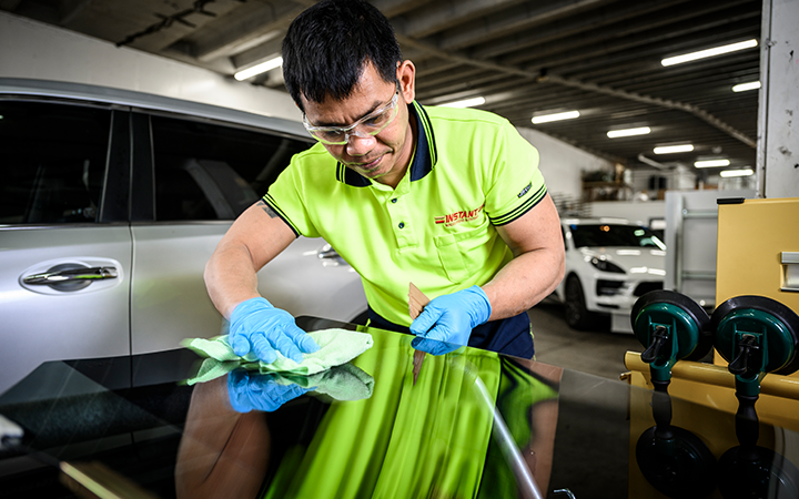 Larry Dolor working on a car windscreen