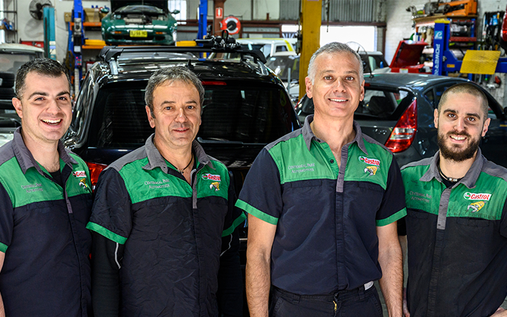 Four mechanicals smiling to camera