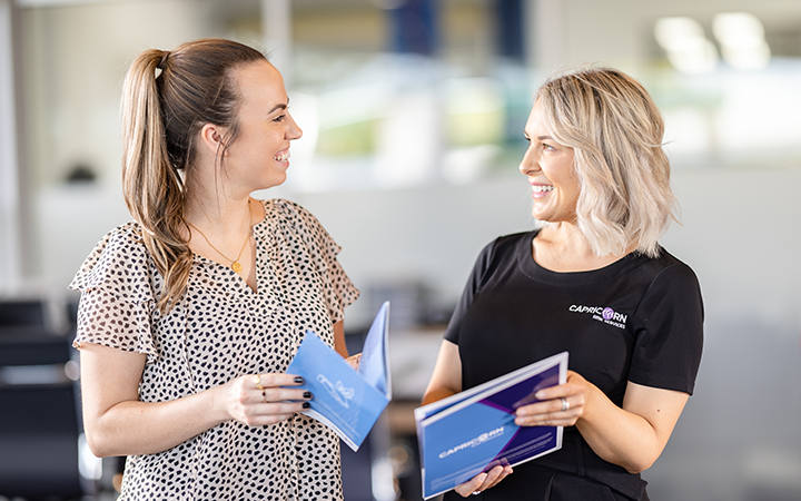 Capricorn Risk Manager showing a brochure to a Member