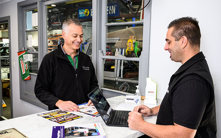 Two men using laptop