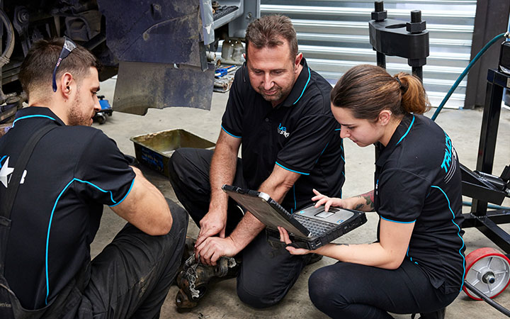 Mechanic with apprentices