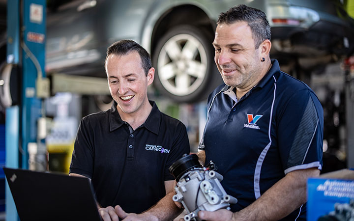 People in workshop on laptop