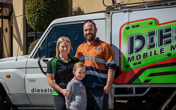 Steve with his wife and daughter smiling to the camera.