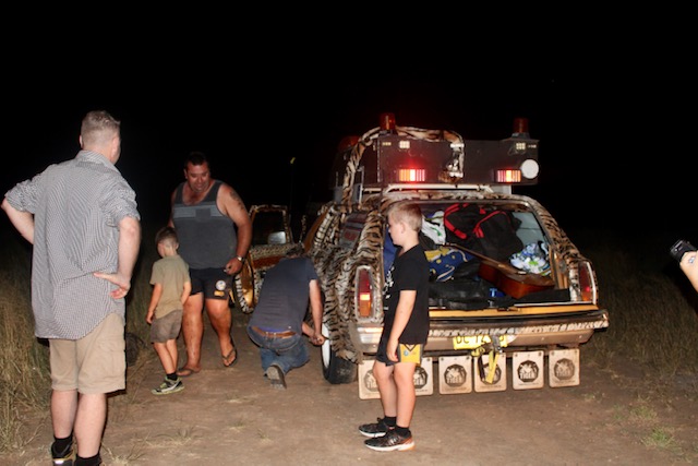 People standing around Tiger Kingswood at night