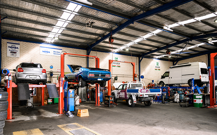 Cars being serviced in a workshop garage