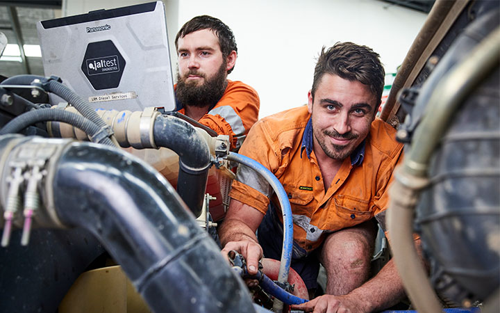 Two men working on truck
