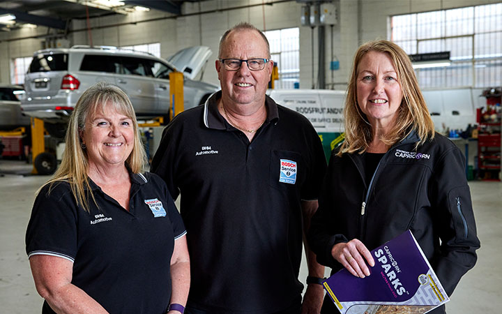 Three people in workshop