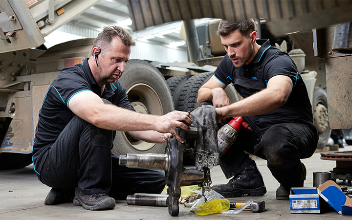 Two men working on engine