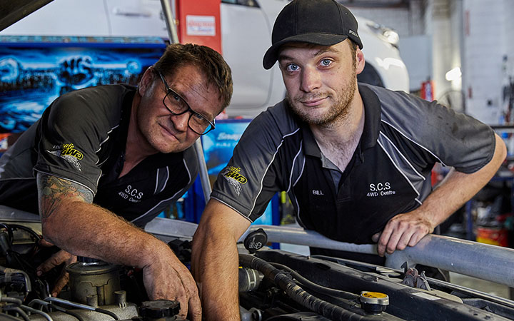 People working on car