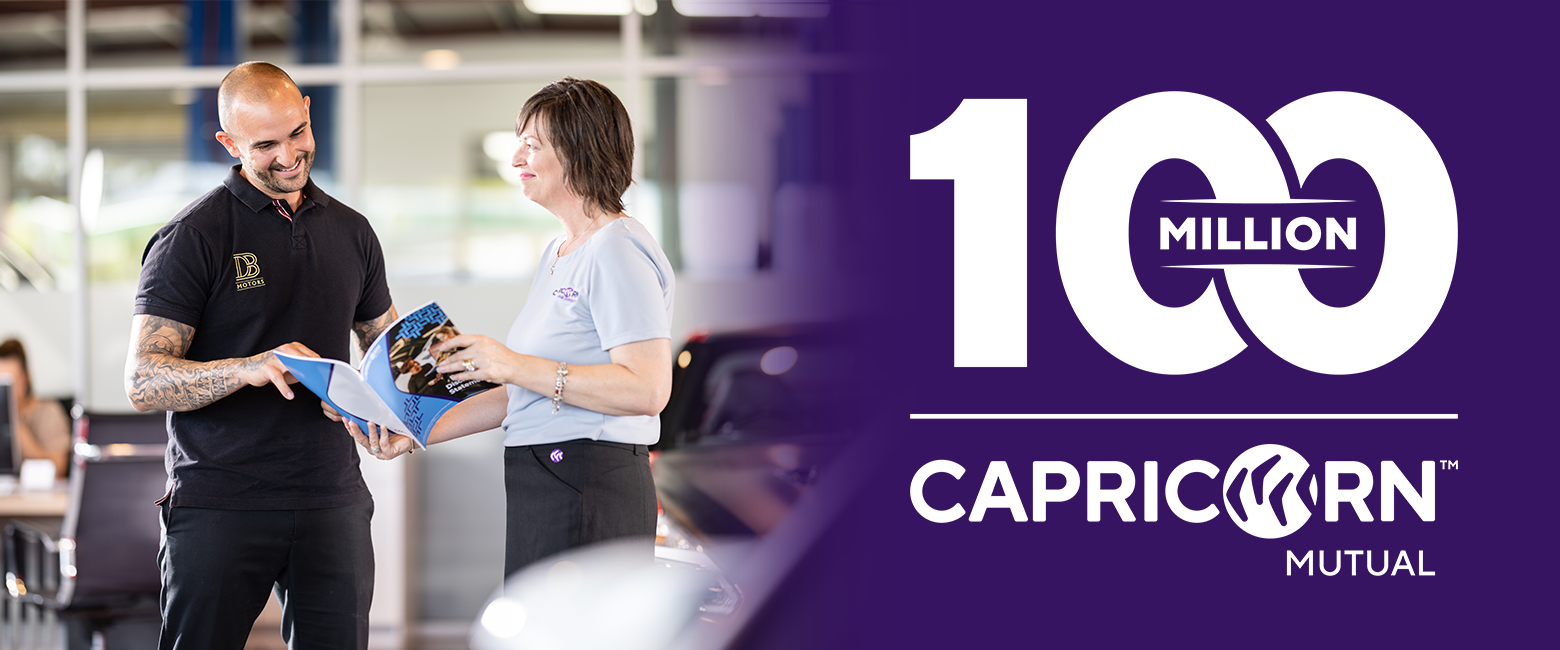 Capricorn's Area Sales Manager showing a brochure to a workshop owner