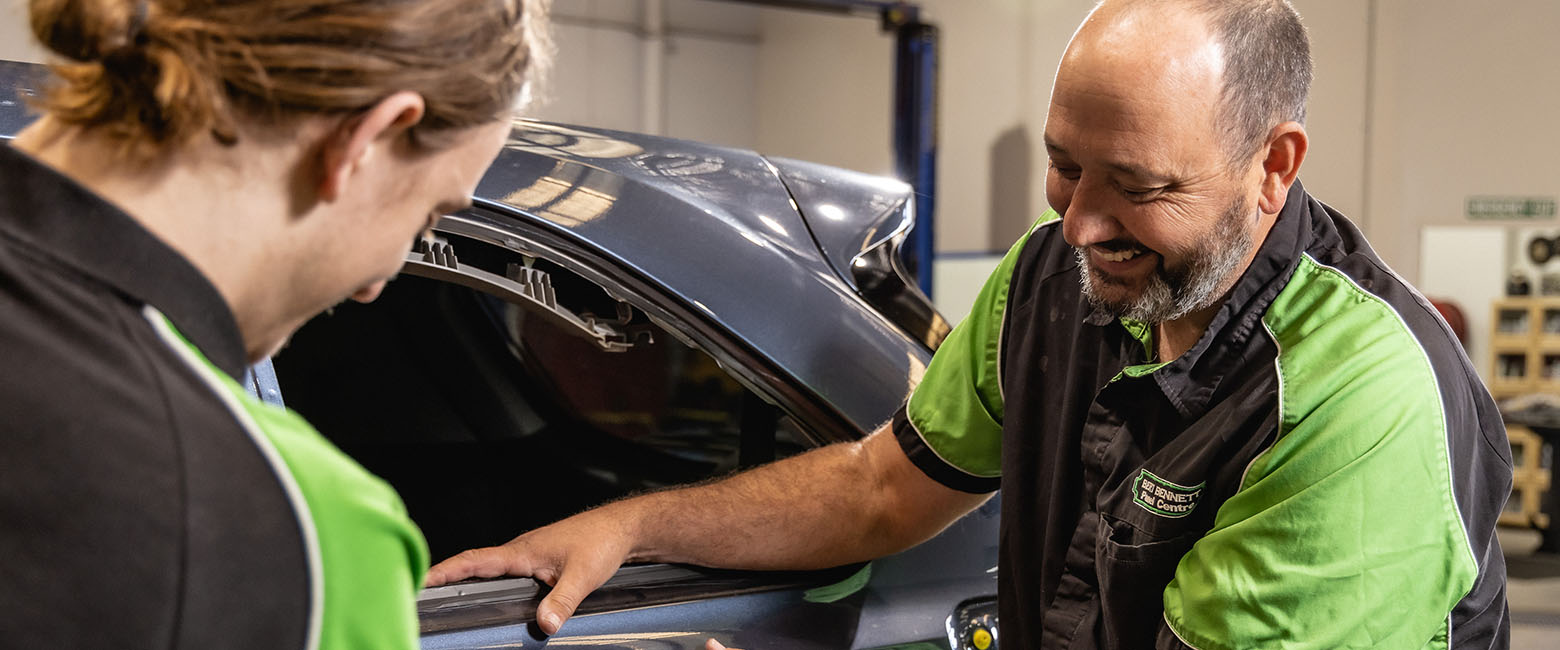Two people working on car