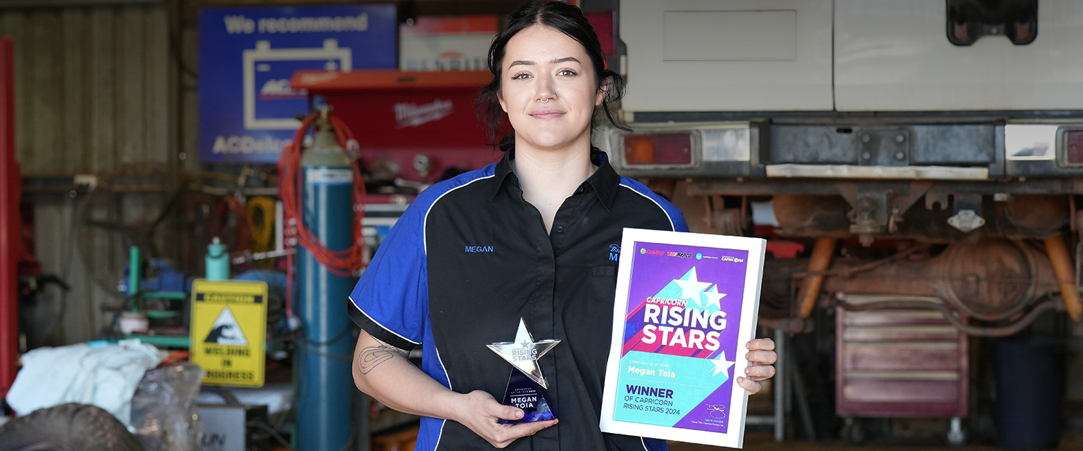 Megan Toia, the 2024 Capricorn Rising Stars Overall Winner, smiles while holding flowers, a certificate and trophy that reads "Capricorn Rising Stars Certificate Mega Toia Winner."