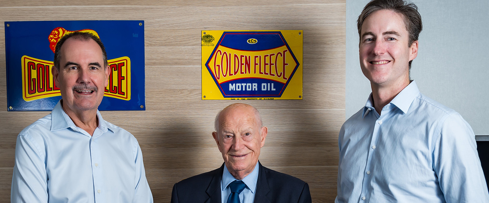 David Fraser, Frank O'Connor and Brad Gannon standing in from of Golden Fleece signage