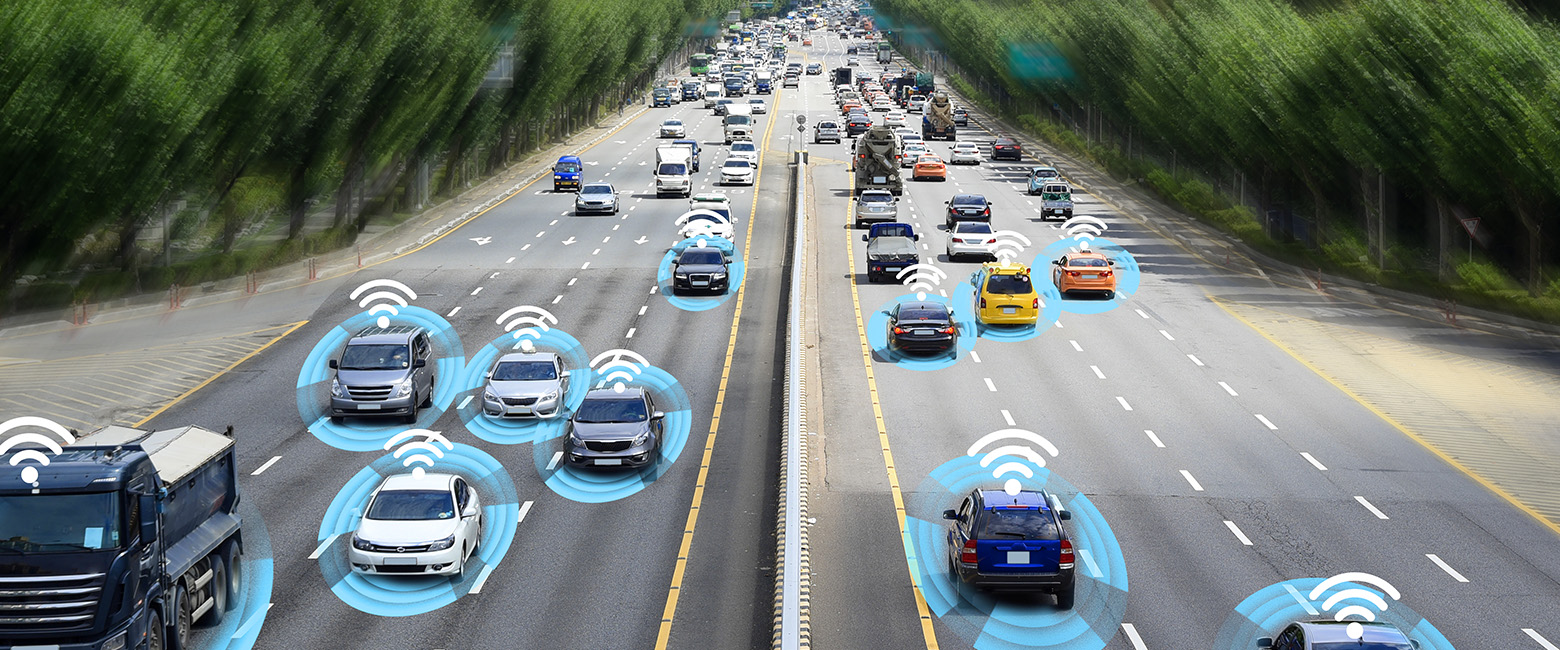 Cars on a highway with wireless icons, showcasing advanced driver assistance systems and evolving automotive technologies.