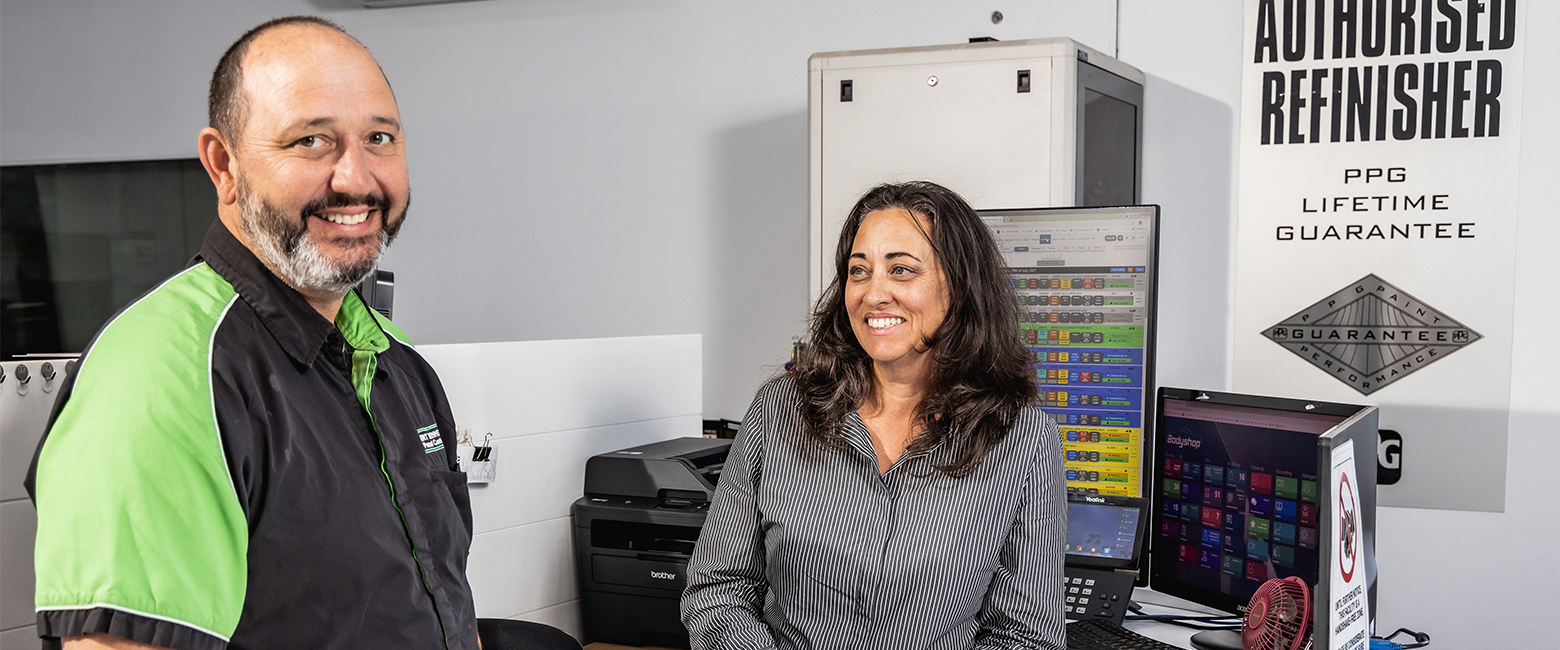 People smiling in an auto business