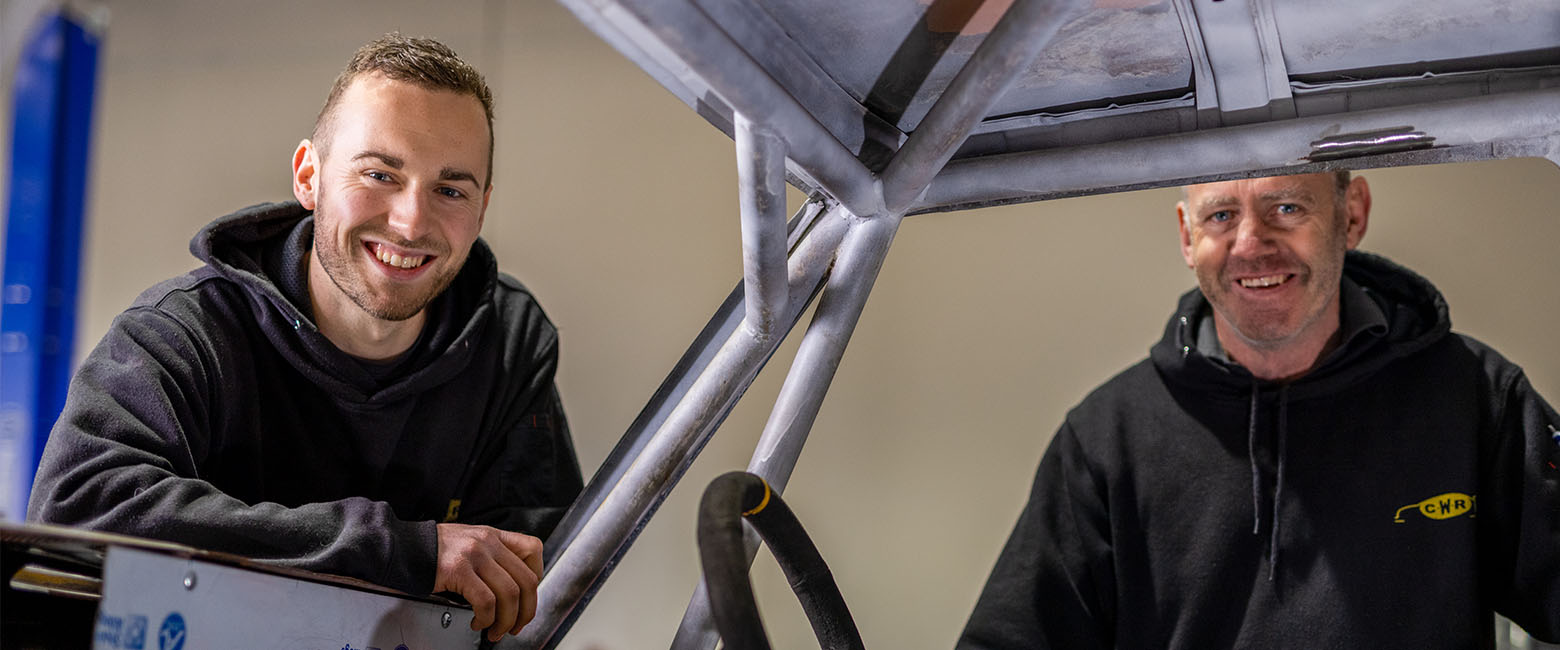 Two people working on car