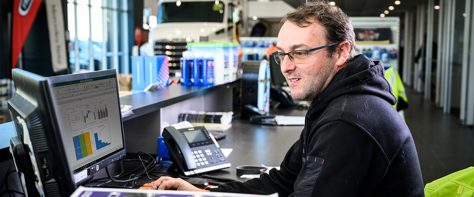 Man sitting at desk doing work on a computer