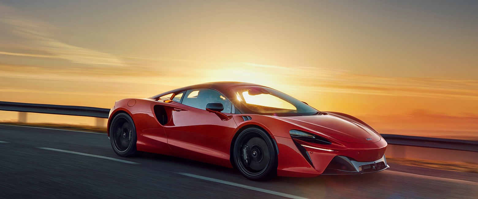 Mclaren Artura being driven at the sunset
