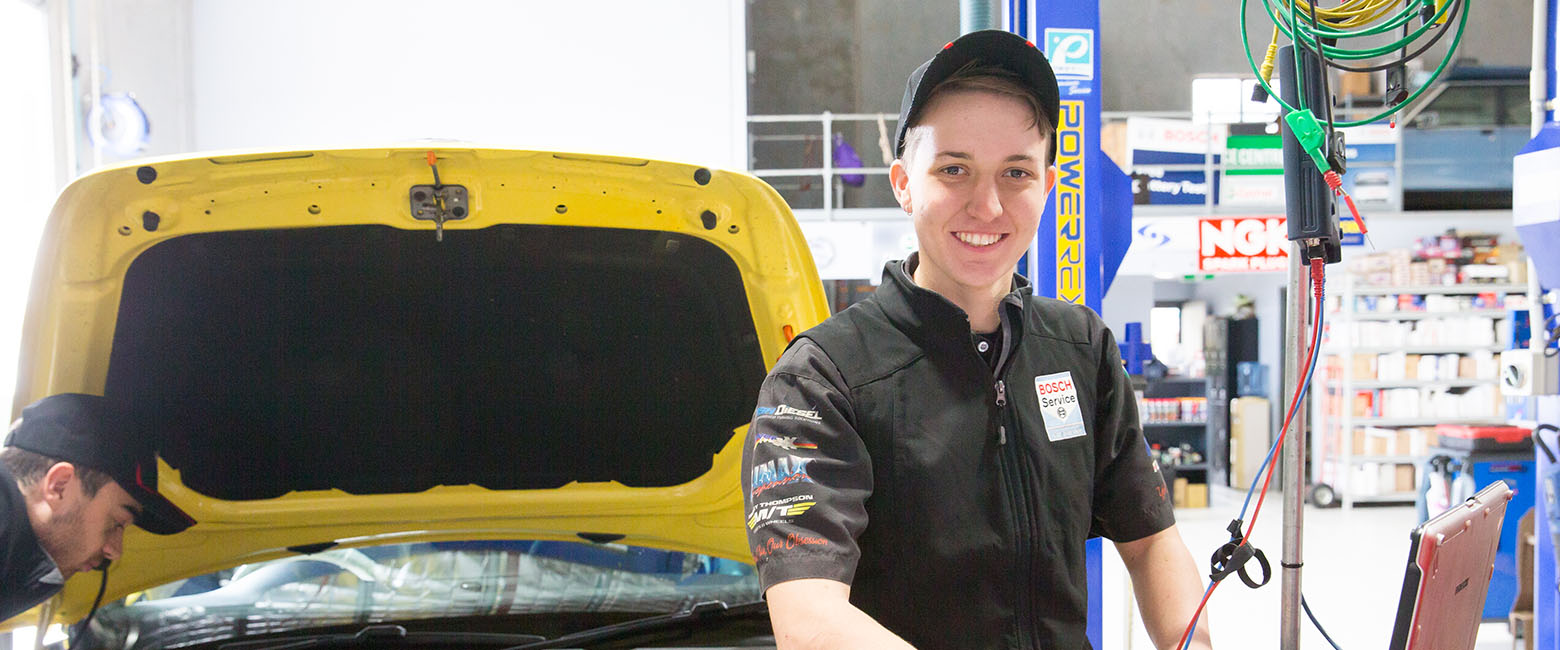 People fixing vehicle