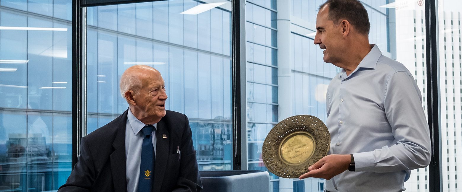 Frank and David looking at each other while checking some Capricorn items from the past