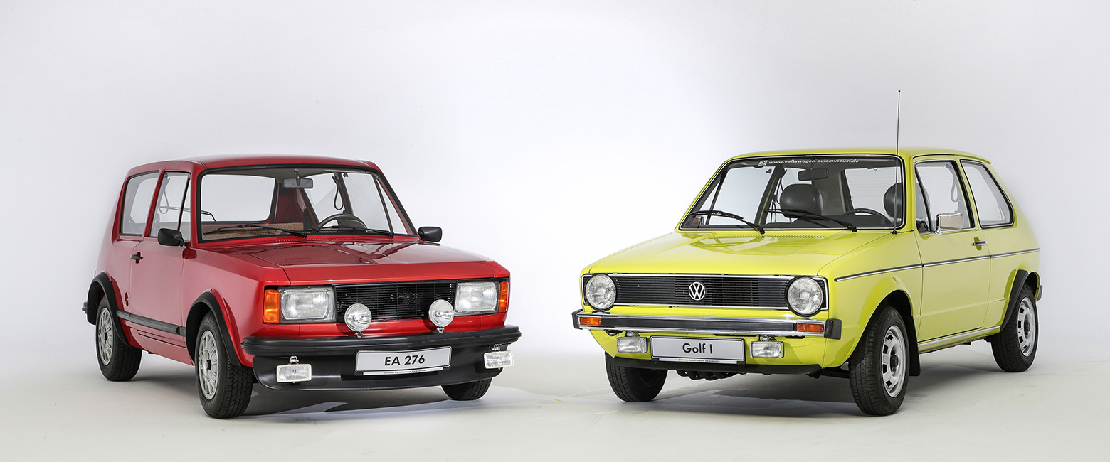 Two first-generation VW Golf cars parked side by side, showcasing their classic design and compact size.