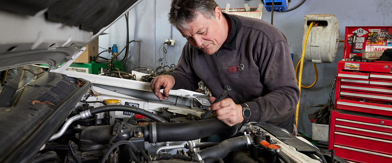 Mechanic checking a car enigineer