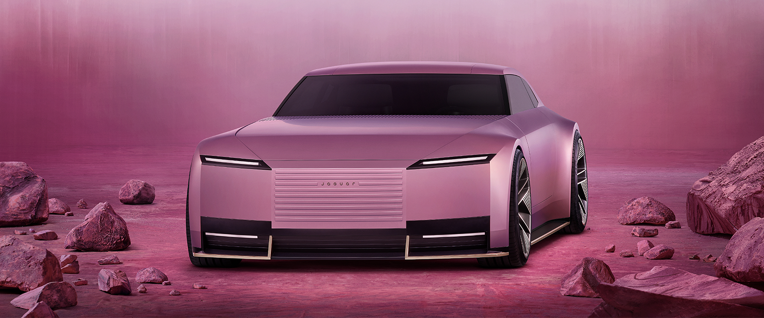 A pink jaguar Type 00 concept car on a pink landscape featuring pink rocks