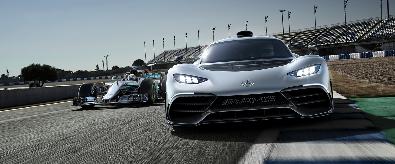 The Mercedes-AMG ONE hypercar displayed on the track alongside a Mercedes F1 car, showcasing cutting-edge automotive design.