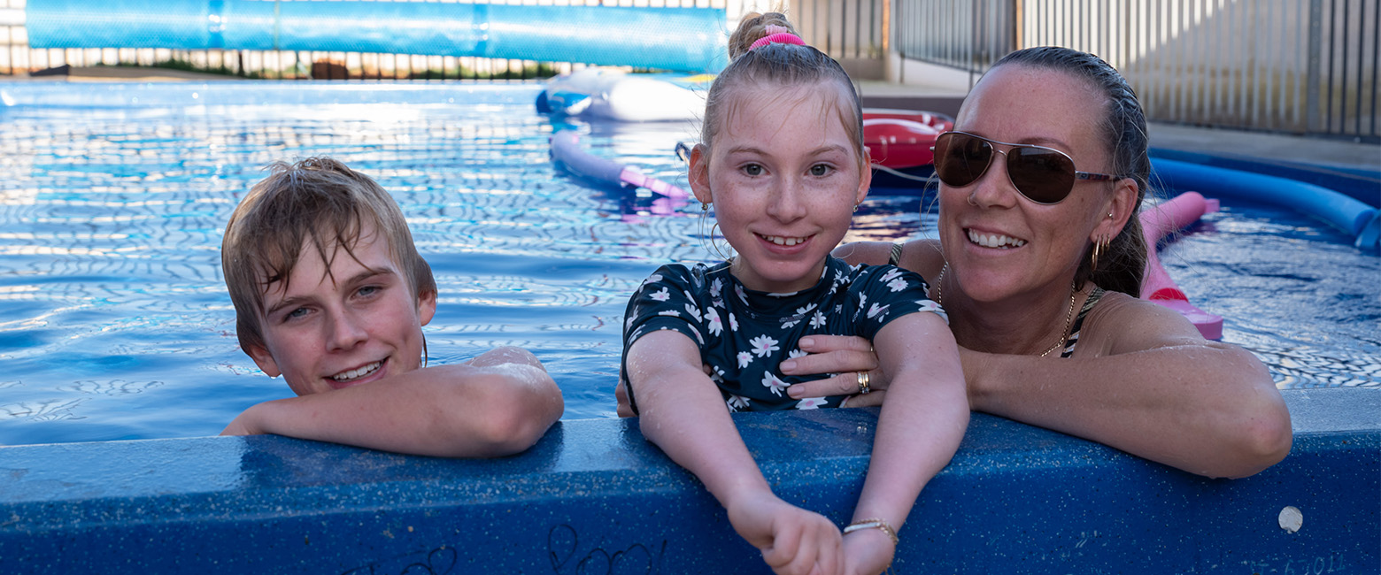 Pippa Funneman, her brother and mother smiling in their new pool