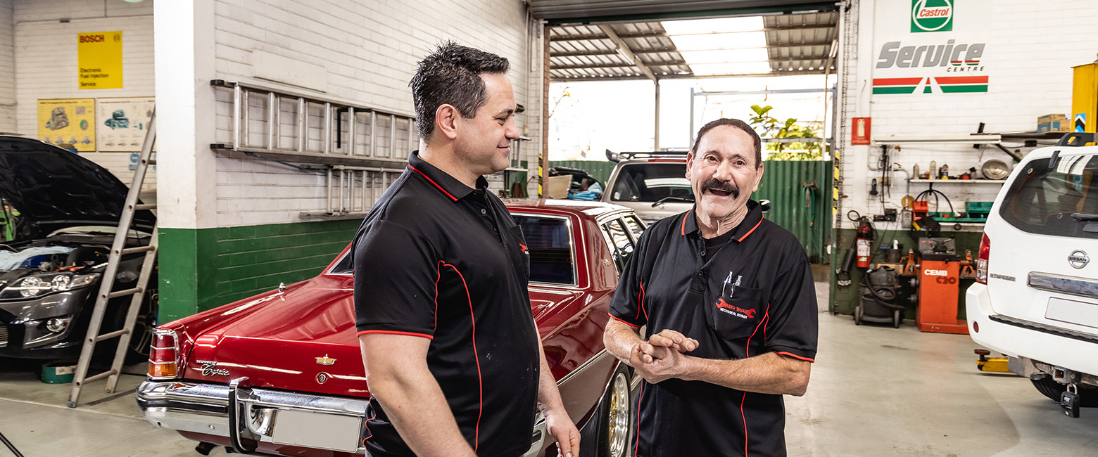 Technicians talking and smiling in the workshop