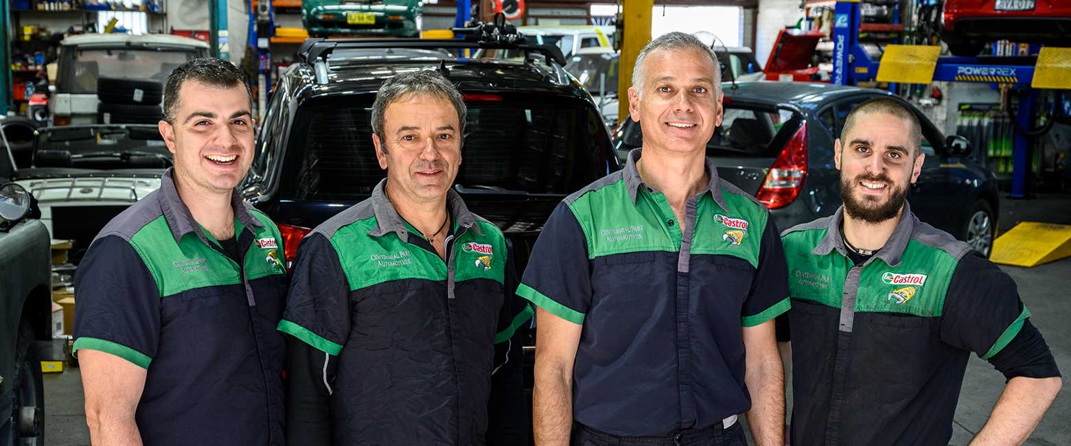 Four mechanicals smiling to camera