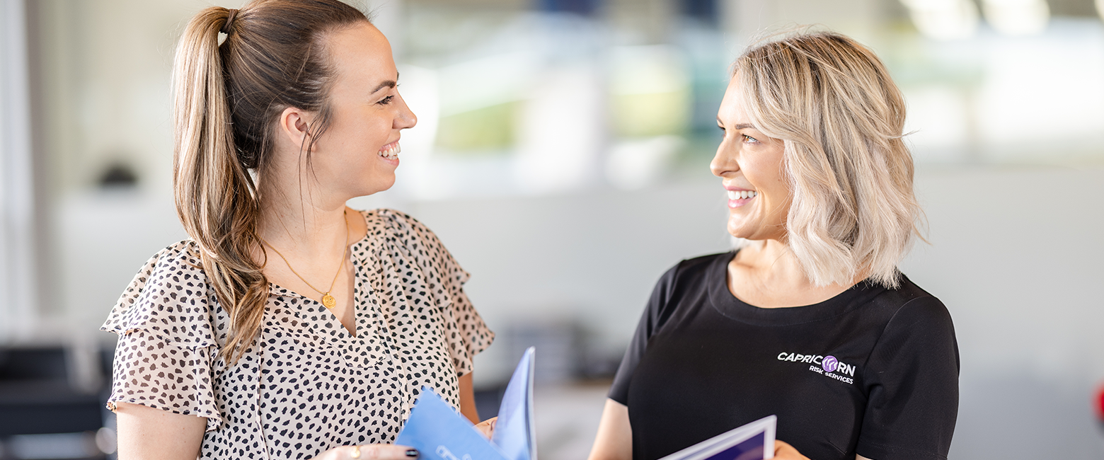 Capricorn Risk Manager showing a brochure to a Member